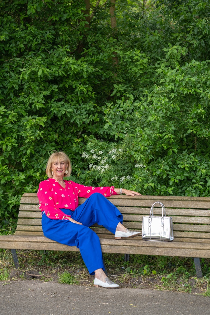 Bright blue trousers with a bright pink blouse