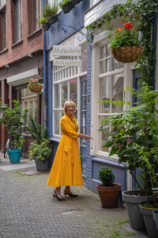 Bright yellow dress with a black and white necklace