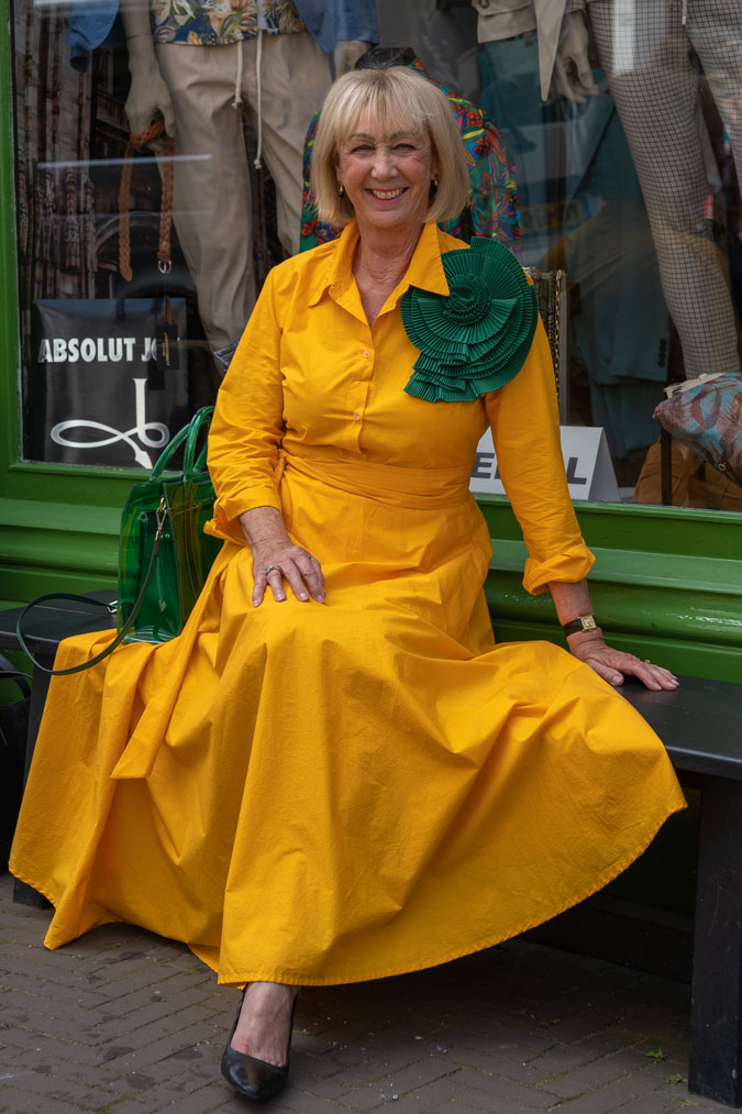 Bright yellow dress with a big green brooch