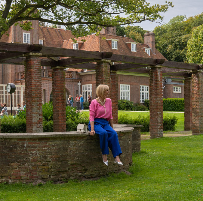 Bright blue trousers with a pink top