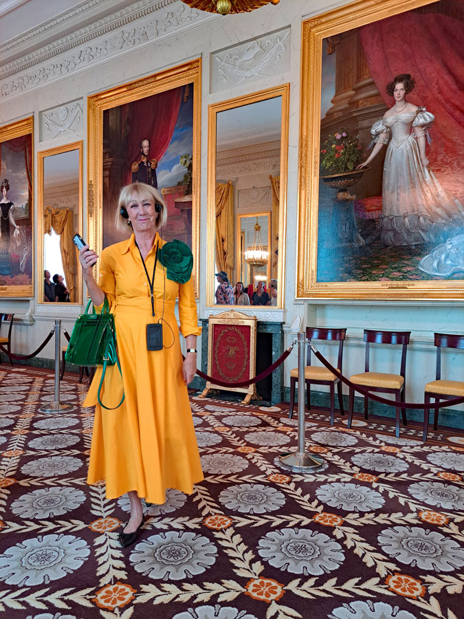 Bright yellow dress with a big green brooch