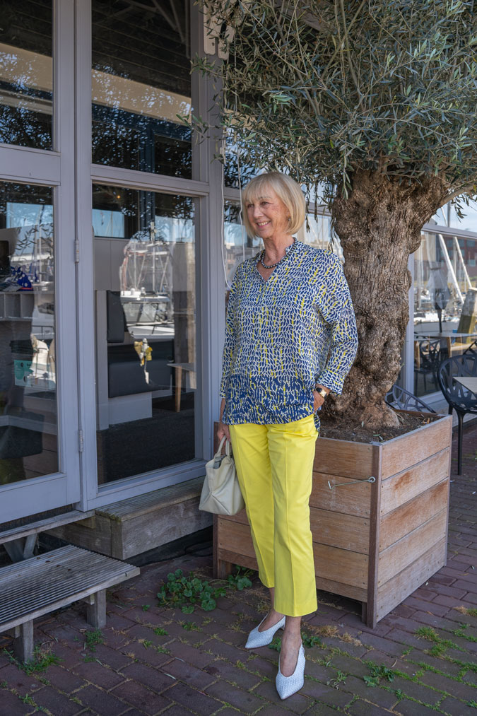 Lemon yellow trousers with a blue, white and yellow blouse