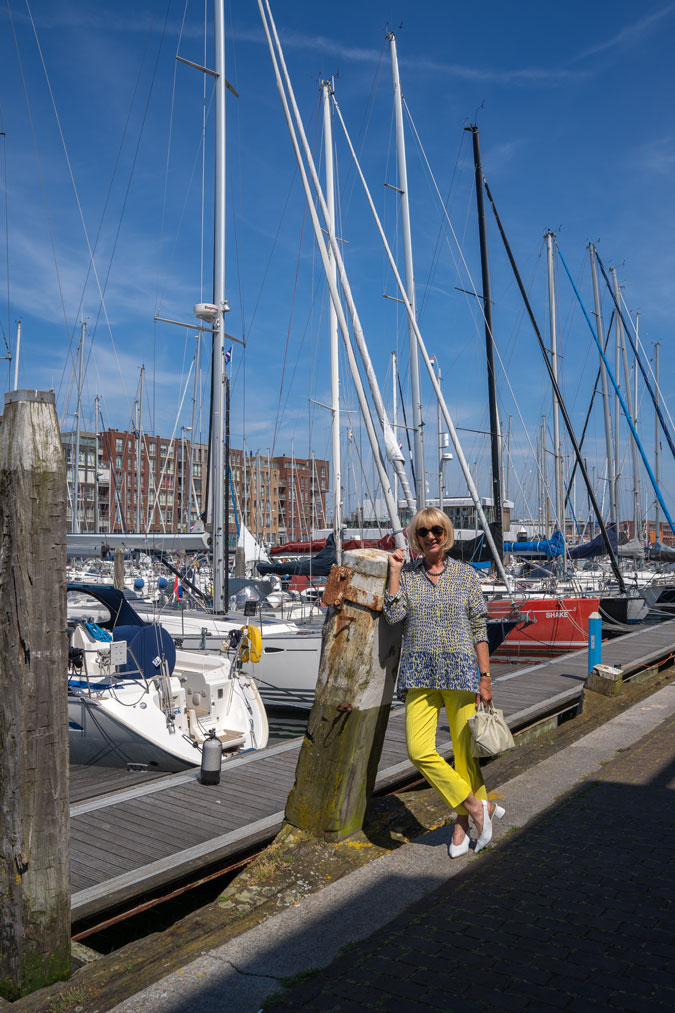 Lemon yellow trousers with a blue, white and yellow blouse