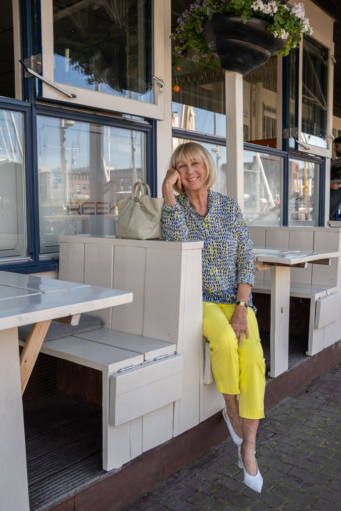 Lemon yellow trousers with a blue, white and yellow blouse