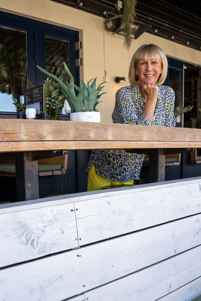 Lemon yellow trousers with a blue, white and yellow blouse