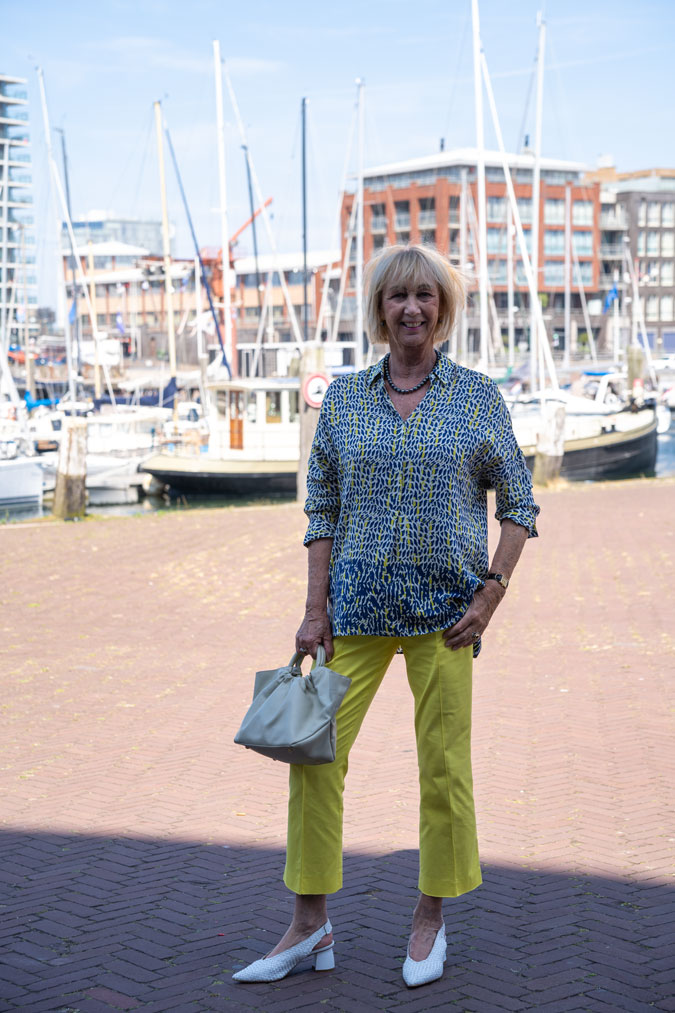 Lemon yellow trousers with a blue, white and yellow blouse