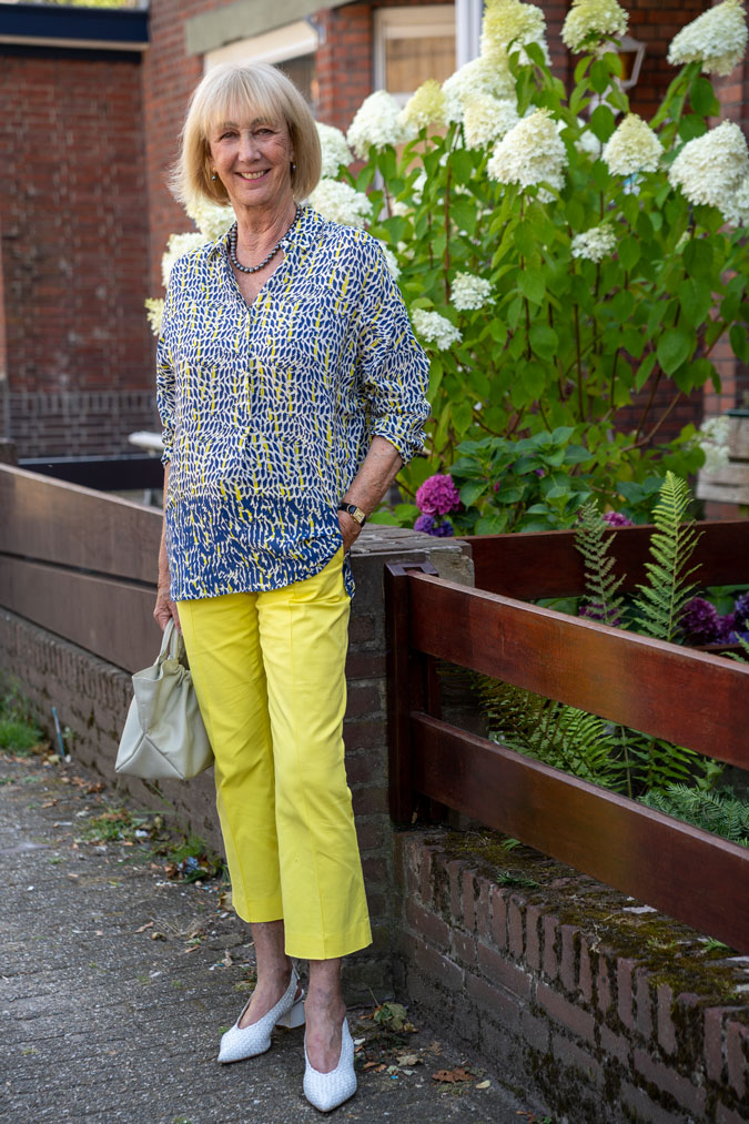 Lemon yellow trousers with a blue, white and yellow blouse